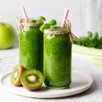 green smoothie of spinach, apple and kiwi on a light background